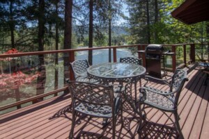 deck overlooking river with table and chairs