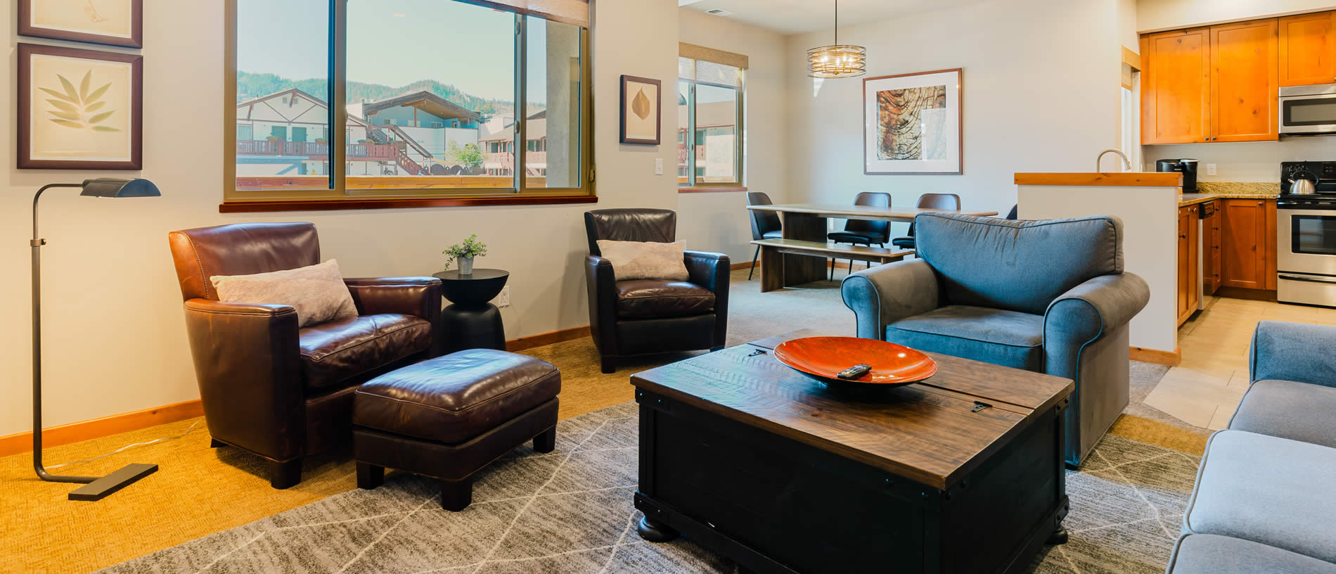 obertal townhome living room with couch, table, chairs, kitchen view